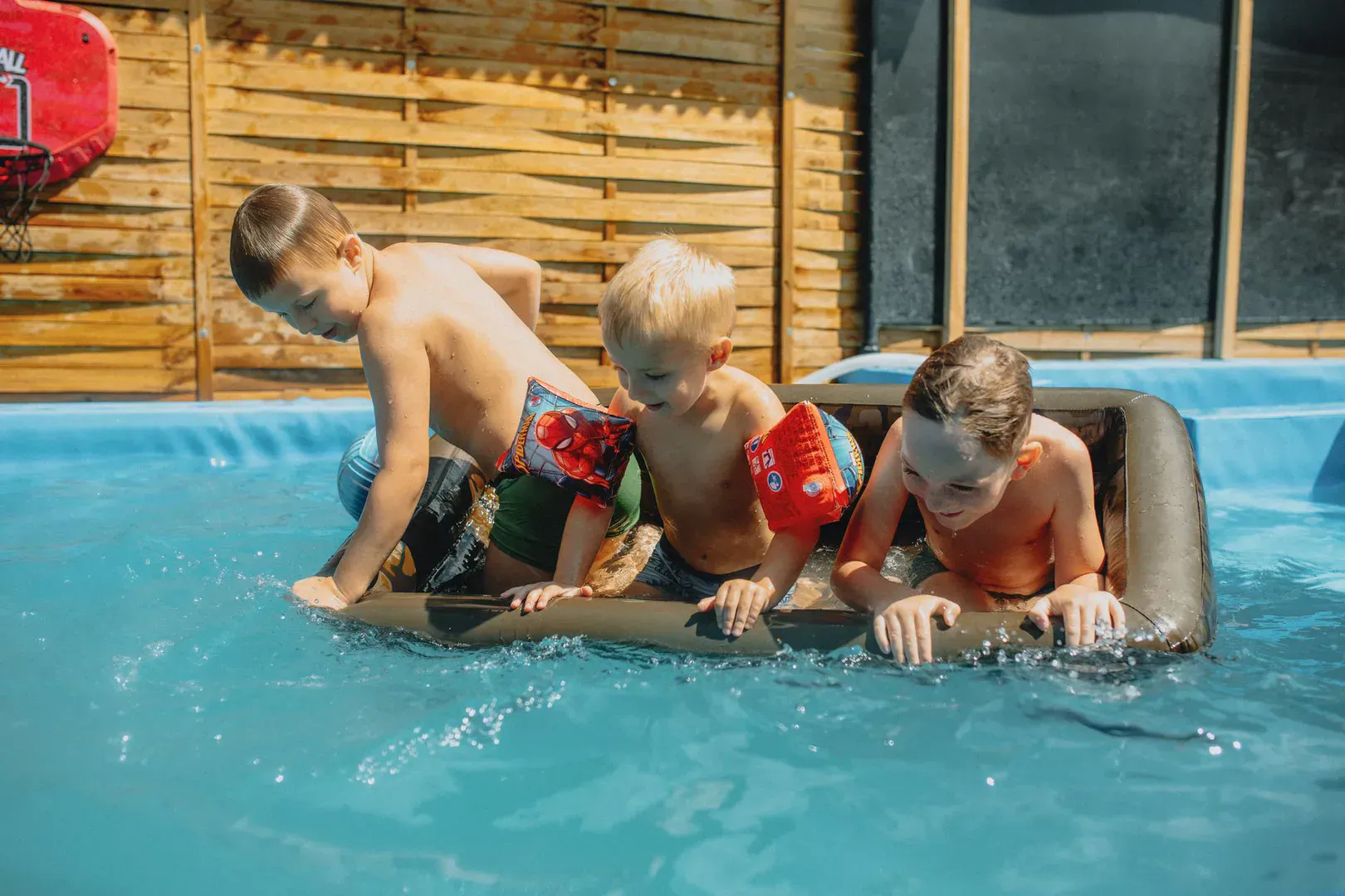 A bright inflatable cornhole and ring toss setup on a sunny backyard lawn, the kind of buy-to-own gear you want from the best inflatable yard games