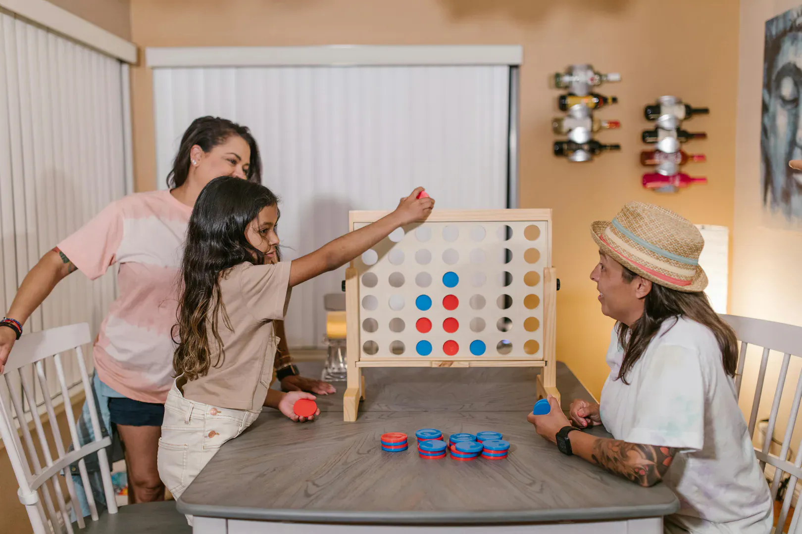 A family playing the classic Connect Four four-in-a-row game